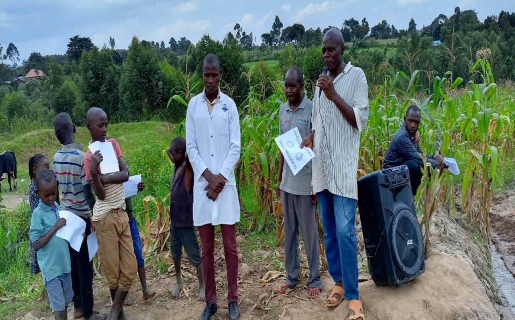 A community leader making a speech near the well