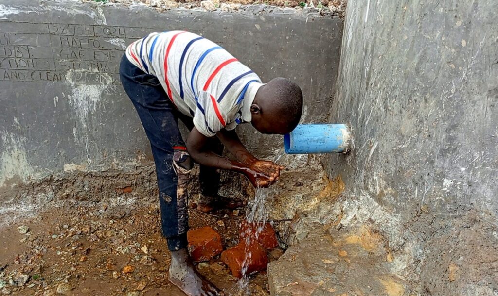 Water being collected after the Kafubi well was built